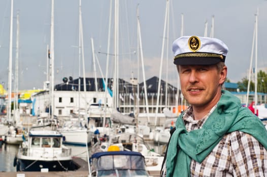 Portrait of a man in a sailor's Cap on the deck of a sailboat
