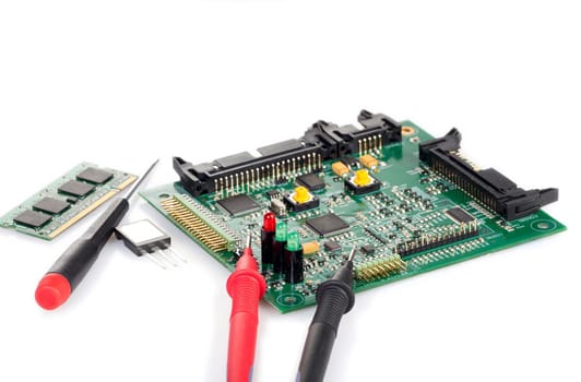 PCB with components and tools on white background
