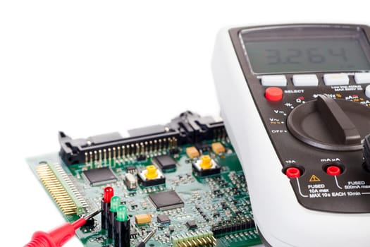 Digital multimeter and board on white background