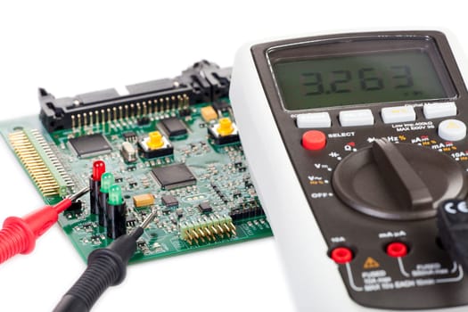 Digital multimeter and board on white background