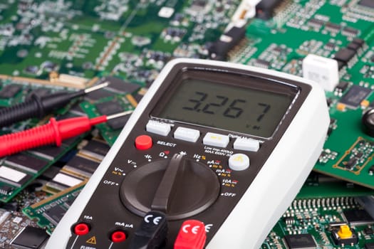 Digital Multimeter lies on circuit boards