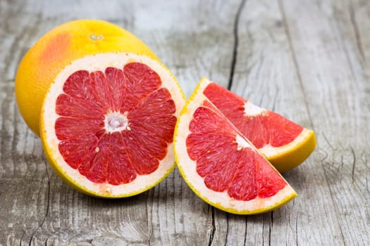 red grapefruit on old wooden background
