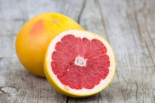 red grapefruit on old wooden background