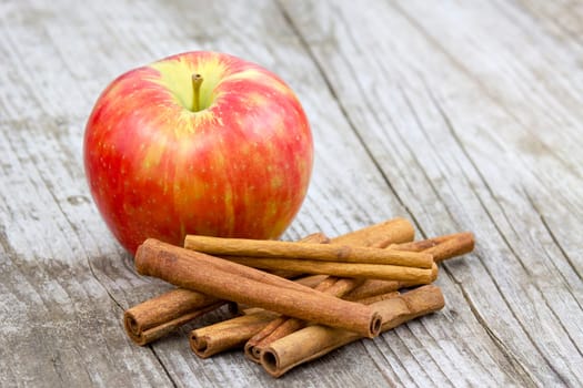 Red apple and cinnamon sticks