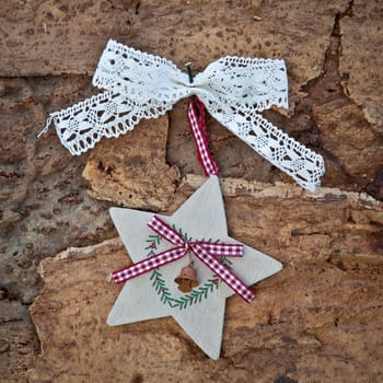 Rustic background with Christmas decoration on tree bark