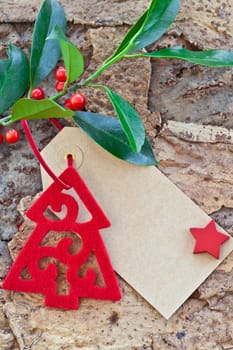 Rustic background with Christmas decorations and holly branches