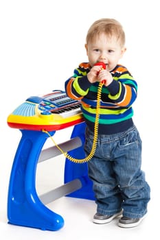 little boy and the keyboard on white background. funny boy baby. young DJ
