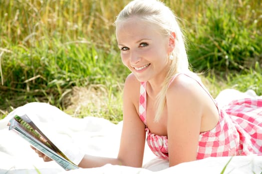 Young woman reads newspaper