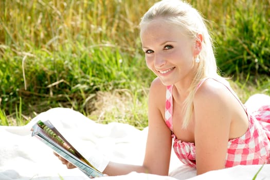 Young woman reads newspaper