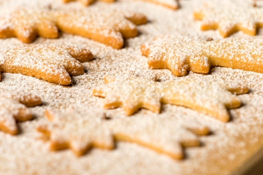Baking christmas cookies comet star with powdered sugar