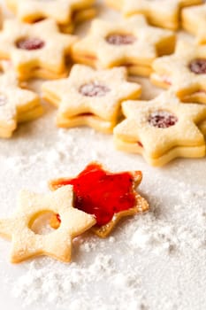 Gingerbread christmas cookie star with jam and powdered sugar