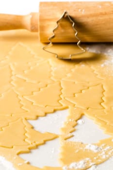 Christmas cookie dough baking sweets with rolling pin and cutter