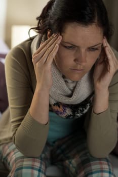 Portrait of young woman suffering from headache