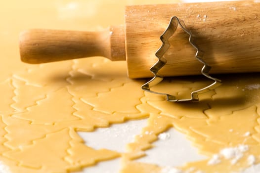 Baking christmas cookies raw dough with rolling pin and cutter