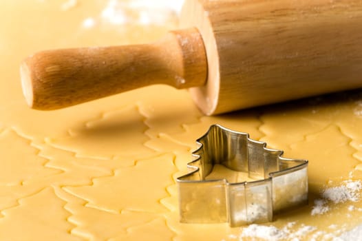 Christmas cookie dough baking sweets with rolling pin and cutter
