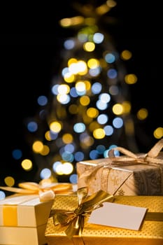 Christmas gift gold ribbon with a christmas tree in the background