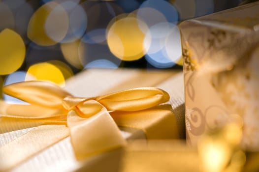 Christmas Gifts wrapped in golden paper and ribbon