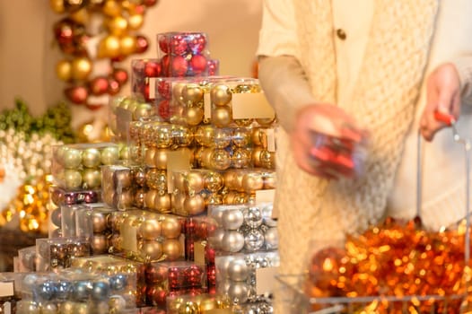 Customer shopping Christmas decorations balls putting to shopping basket