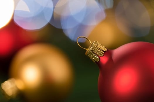 Christmas red and gold balls close-up shining lights background
