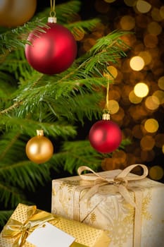 Christmas decoration tree, baubles and gifts on shining lights background