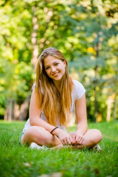 Portrait of young beautiful woman (teenage girl) - outside on grass