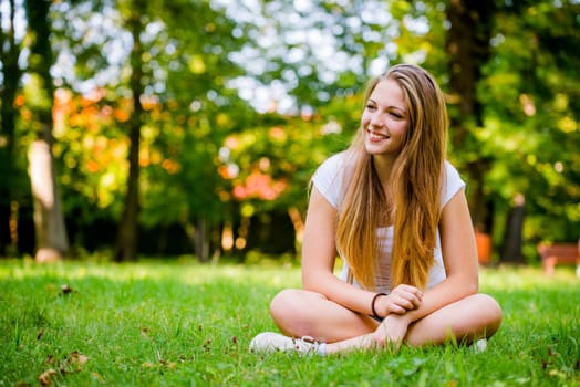 Young beautiful woman (teen girl) looking to side - outdoor in nature