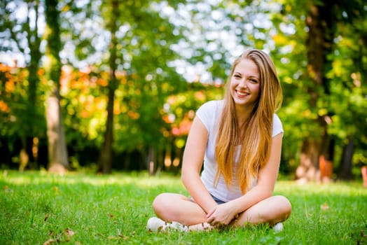 Portrait of young beautiful woman (teenage girl) - outside on grass