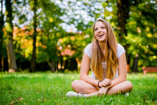 Young beautiful woman (teen girl) looking to side - outdoor in nature