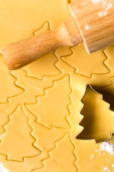 Baking christmas cookies raw dough with rolling pin and cutter