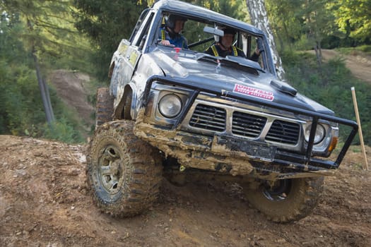 MOHELNICE, CZECH REPUBLIC - OCT 05. Black off-road car on a difficult terrain on a trial race in the "BIG SHOCK CUP Trial 2013"" on October 05, 2013 in Mohelnice, Czech Republic."