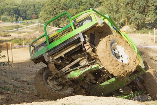 MOHELNICE, CZECH REPUBLIC - OCT 05. Green off-road car on a trial race in the "BIG SHOCK CUP Trial 2013"" on October 05, 2013 in Mohelnice, Czech Republic."
