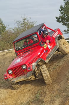 MOHELNICE, CZECH REPUBLIC - OCT 05. Red off-road car on a trial race in the "BIG SHOCK CUP Trial 2013"" on October 05, 2013 in Mohelnice, Czech Republic."