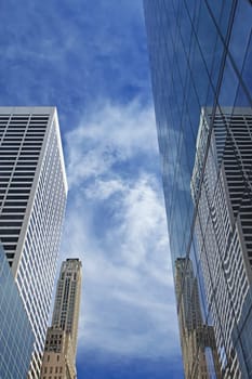 Skyscrapers in New York City. Blue sky in the background. Vertically.