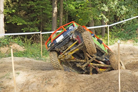 MOHELNICE, CZECH REPUBLIC - OCT 05. Overturning off-road car on a trial race in the "BIG SHOCK CUP Trial 2013"" on October 05, 2013 in Mohelnice, Czech Republic."