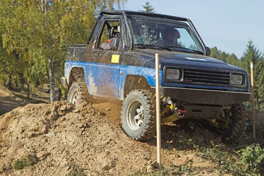 MOHELNICE, CZECH REPUBLIC - OCT 05. Blue off-road car on a trial race in the "BIG SHOCK CUP Trial 2013"" on October 05, 2013 in Mohelnice, Czech Republic."