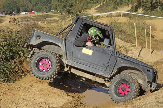 MOHELNICE, CZECH REPUBLIC - OCT 05. Off-road car is owercoming a terrain  on a trial race in the "BIG SHOCK CUP Trial 2013"" on October 05, 2013 in Mohelnice, Czech Republic."