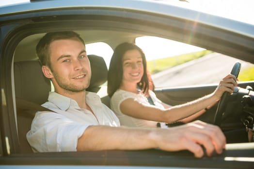 Happy time together - couple in car, woman is driving
