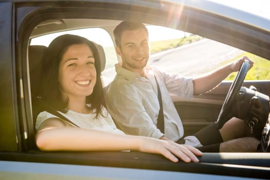Happy time together - couple in car, man is driving