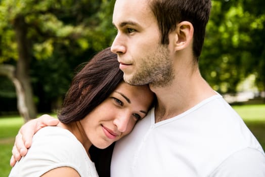 Romantic moments - young couple together, woman's head laid on men's shoulder of man