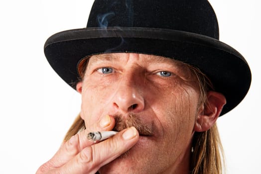 Man with bowler hat is smoking