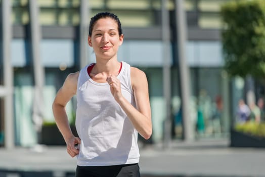 Running lifestyle - young sport woman jogging in street