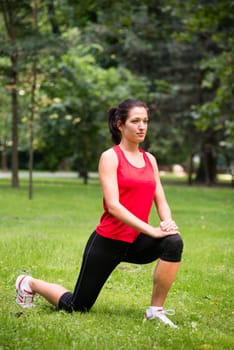 Young sport woman exercising before jogging - outside in nature
