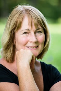 Portrait of happy smiling senior woman - outside on sunny day