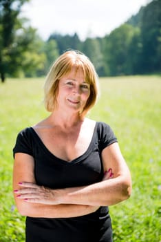 Portrait of attractive senior woman - outdoor on sunny day