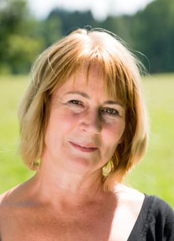 Portrait of attractive senior woman - outdoor on sunny day