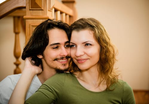 Portrait of young happy smiling couple - indoor settinguple portrait