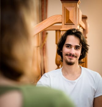 Portrait of young smiling man - view over shoulder of woman