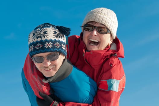 Active senior couple - smiling mature man and woman outdoor in winter
