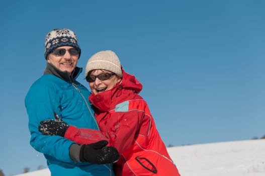 Portrait of smiling happy senior retired couple - outdoor in winter