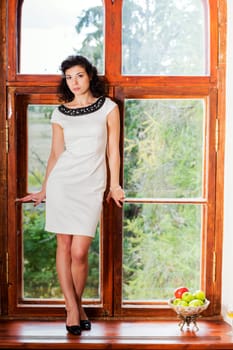 Woman in nice dress stand on wooden sill